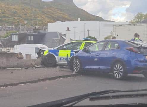 A police car has crashed through the garden wall of a home during a high-speed chase in Restalrig. (Credit: Dean Loughton)