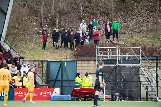 Hearts fans watch from outside the ground after failing to get a ticket. More than 5,000 Jambos travelled to the Tony Macaroni Arena. Picture: Ross Parker / SNS