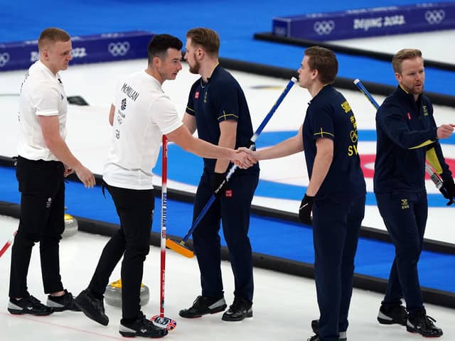 Great Britain's Hammy McMillan and Bobby Lammie shake hands with Sweden team after losing the Men's Gold Medal game.
