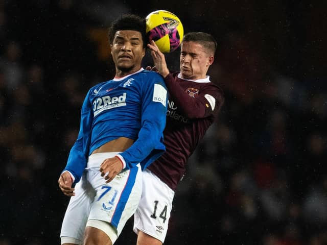 Rangers forward Malik Tillman and Hearts midfielder Cammy Devlin challenge for the ball at Ibrox.
