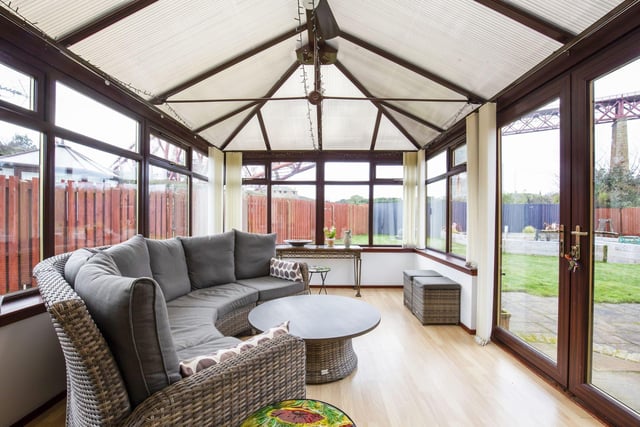 Sliding patio doors lead to a generously sized conservatory, giving direct access to the private landscaped rear garden.