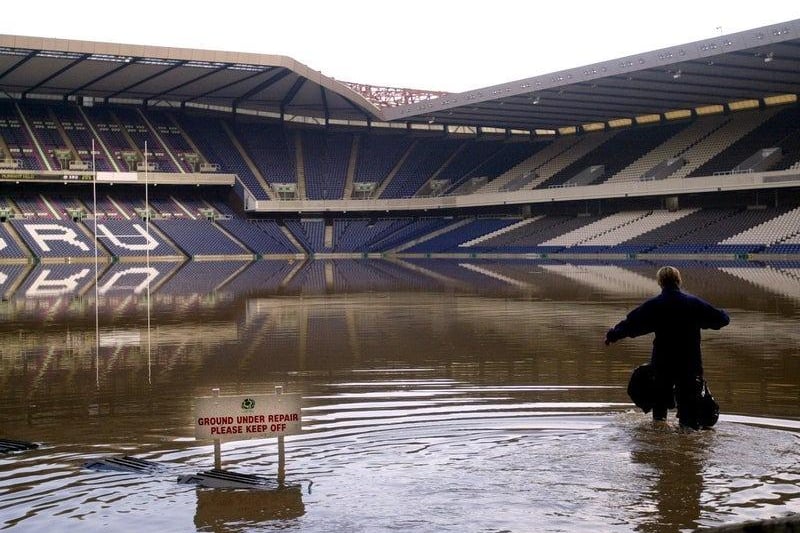 Following heavy rainfall in April 2000, Murrayfield Stadium was flooded. Here you can see the head groundsperson Heath MacKinnon as she wades through the water.