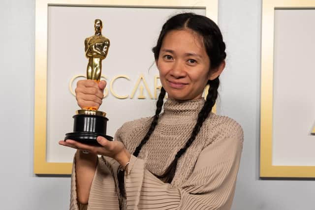 Chloe Zhao posing backstage with the Oscar for Directing, for the film Nomadland, at the 93rd Academy Awards ceremony.