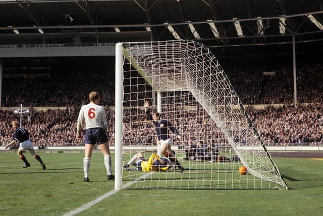 Ian St John celebrates scoring against England at Wembley in 1965.