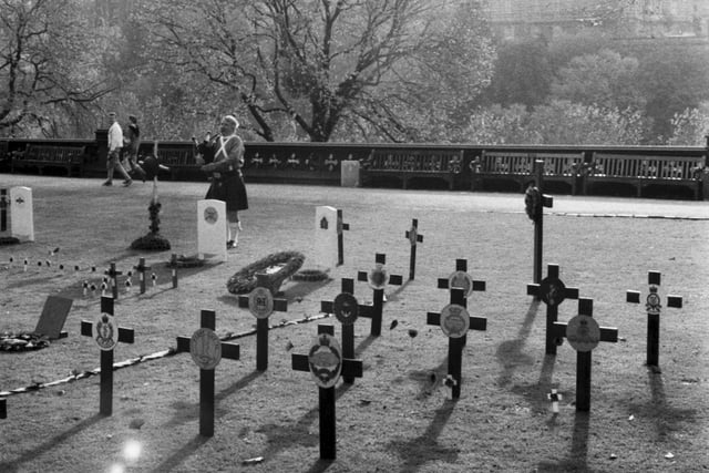 A lone piper plays by the crosses of the Garden of Remembrance in Edinburgh's Princes Street Gardens as the sun sets on Remembrance Sunday 1985.