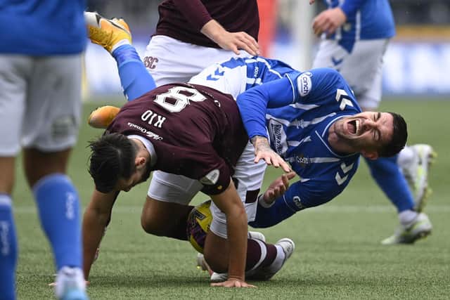 Orestis Kiomourtzoglou, seen here making a challenge on ex-Hearts striker Kyle Lafferty, has had to get used to the physical nature of Scottish football. Picture: SNS