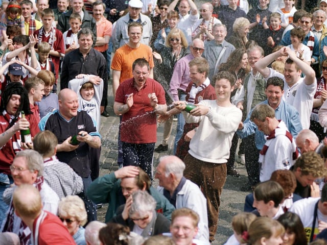 Hearts fans celebrate their team winning the Tennents Scottish Cup in 1998.