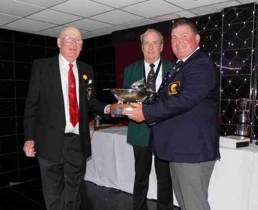 Ronnie Gilbert, right, receiving the Brown Bowl from International Fly Fishing Association (IFFA) president, Paul Sharman, left, and IFFA secretary Michael Callaghan