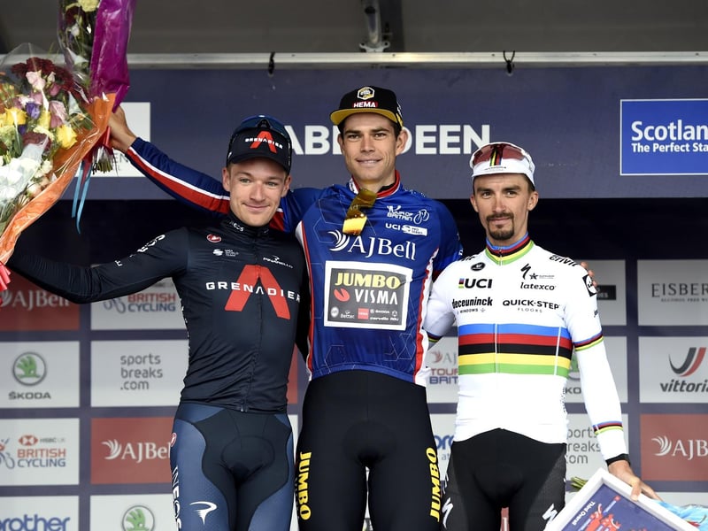 Team Jumbo-Visma Cycling's Wout Van Aert (centre) celebrates winning stage eight of the AJ Bell Tour of Britain from Stonehaven to Aberdeen and the overall Tour of Britain alongside second placed INEOS Grenadiers' Ethan Hayter (left) and Third placed Deceuninck Quick-Step's Julian Alaphilippe.