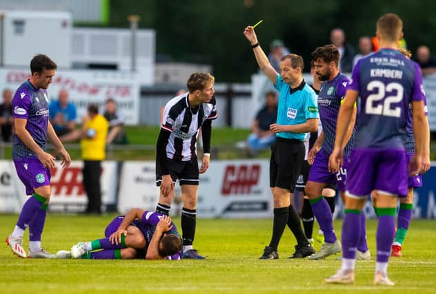 You're booked - ref Willie Collum shows Elgin City's  Kane Hester a yellow card