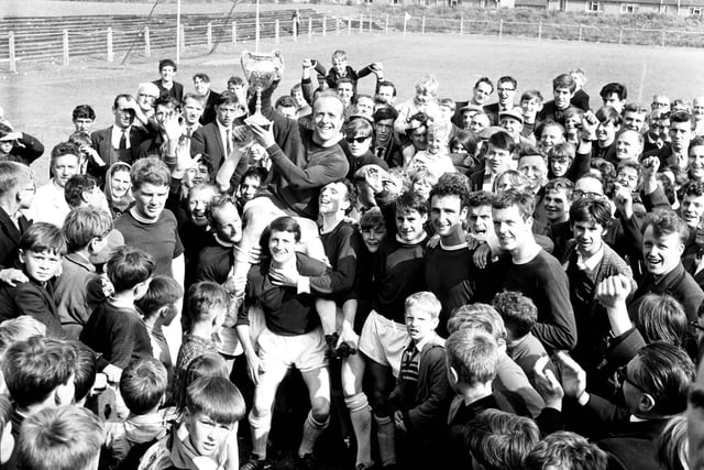 Tommy Reston, captain of Linlithgow Rose FC is carried shoulder high by locals after the team beat Bonnyrigg Rose FC in the Scottish Junior Cup in June 1966.