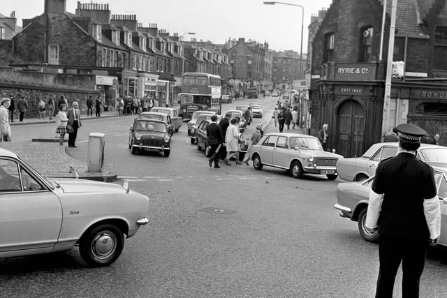 Before the pedestrian crossing was installed - pedestrians brave the traffic at Haymarket by Ryrie's bar as a traffic policeman looks on in August 1971.