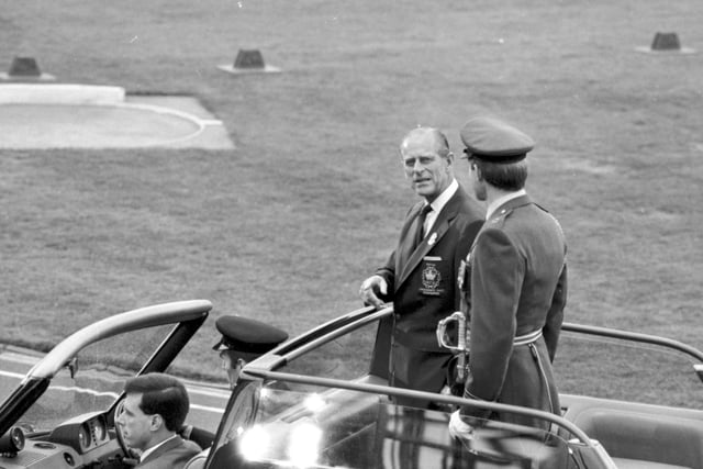 The Duke of Edinburgh is driven round the track at the 1986 opening ceremony.