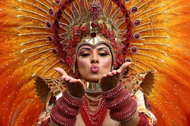 A performer in costume blows a kiss during the main parade of the Notting Hill Carnival in west London on August 27, 2023. (Photo by HENRY NICHOLLS / AFP) (Photo by HENRY NICHOLLS/AFP via Getty Images)