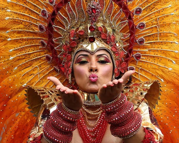 A performer in costume blows a kiss during the main parade of the Notting Hill Carnival in west London on August 27, 2023. (Photo by HENRY NICHOLLS / AFP) (Photo by HENRY NICHOLLS/AFP via Getty Images)