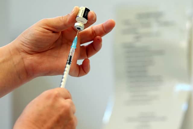 A nurse prepares a dose of a Pfizer booster vaccine at a vaccination centre. Photo by PAUL ELLIS/AFP via Getty Images