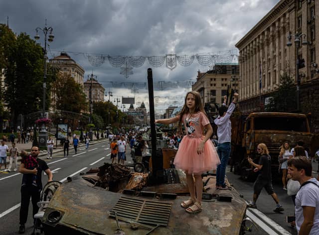 A girl stands on top of a destroyed Russian military vehicle at Khreshchatyk Street in Kyiv, which has been turned into an open-air museum ahead of Ukraine's Independence Day (Picture: Dimitar Dilkoff/AFP via Getty Images)