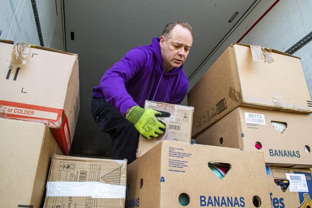 Lorry driver Robert Marshall loads boxes to be freighted to Moldova. Picture: Lisa Ferguson