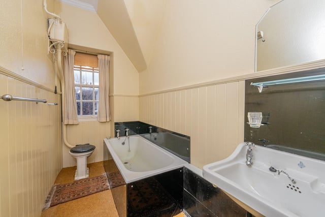 The property's bathroom, with three-piece white suite and window to the rear.