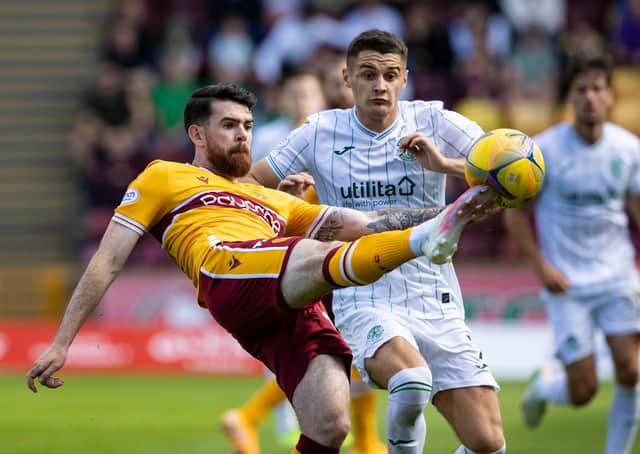 Kyle Magennis battles for the ball with Motherwell's Liam Donnelly
