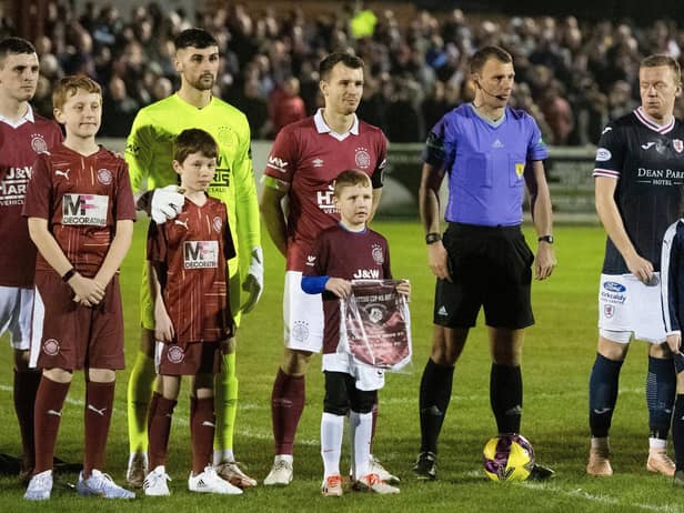 LINLITHGOW, SCOTAND - JANUARY 24: Linlithgow's Greg Skinner, Cammy Binnie and Gary Thom line up before kick off alongside the referee and Raith's Scott Brown during a Scottish Cup fourth round match between Linlithgow Rose and Raith Rovers at Prestonfield, on January 24, 2023, in Linlithgow, Scotland. (Photo by Mark Scates / SNS Group)