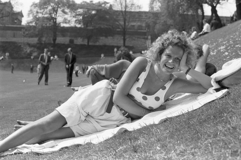 Jackie Murphy tops up her tan, sunbathing in Princes Street gardens during the warm weather in Edinburgh, May 1989.