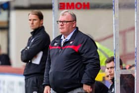 Gillingham manager Steve Evans is keen to sign Hearts midfielder Olly Lee.