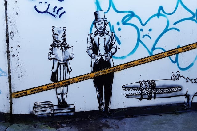 Following a controversial decision to rewrite some of Roald Dahl’s children’s books, street artist, The Rebel Bear, created this artwork on the underpass at Sighthill roundabout on Calder Road earlier in the year. The work includes Willy Wonka in handcuffs with his mouth gagged and Matilda with a bag on her head.