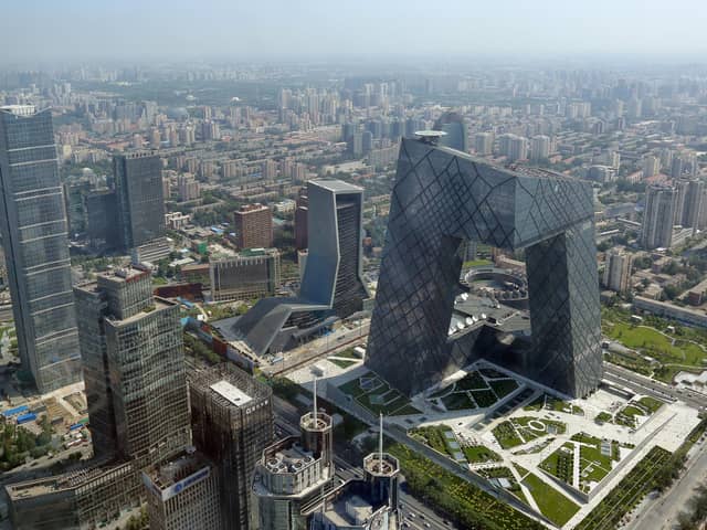 BEIJING, CHINA - AUGUST 03:  A general view shows the headquarter of China Central Television amid the Beijing skyline at central business district on August 3, 2013 in Beijing, China.  (Photo by Feng Li/Getty Images)