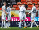 Hibs players celebrate the opening goal