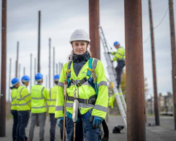An Openreach trainer with apprentices in a pole yard. Pic: Monty Rakusen