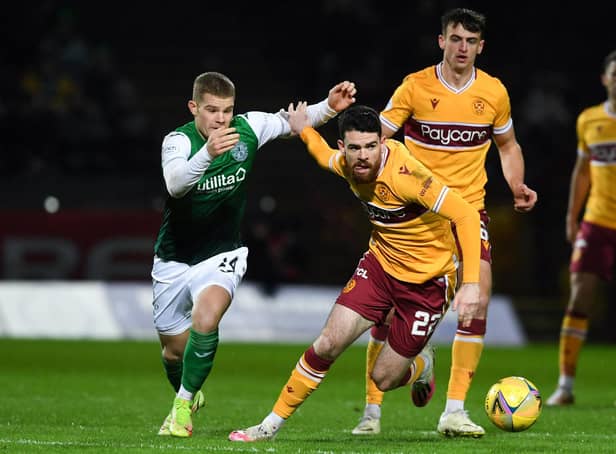 Chris Mueller of Hibs battles with Motherwell's Liam Donnelly during the league meeting last month