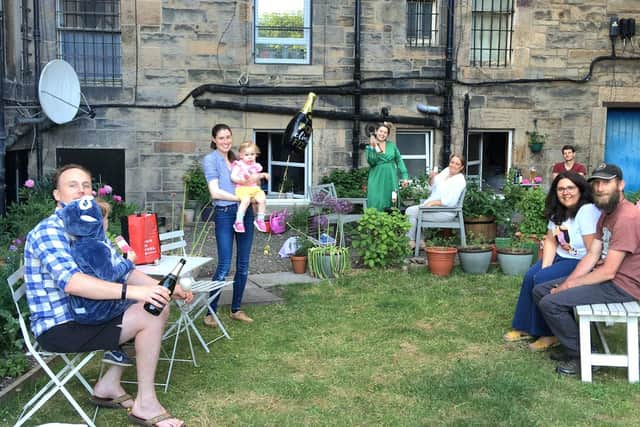 Residents celebrate in the communal garden after their victory in halting student flats in Eyre Place.