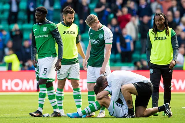 Jamie McAllister consoles Marijan Cabraja after the final whistle in the Hibs-Rangers game