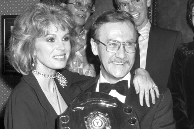 British stage and TV actress Joanna Lumley presents a Muscular Dystrophy fundraising trophy to manager Alan Noble at the Beehive Restaurant in Edinburgh in November 1986.
