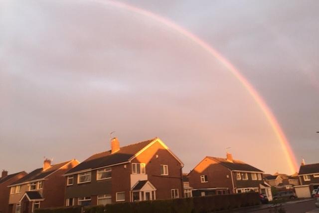 A view of the rainbow over homes in Houghton.