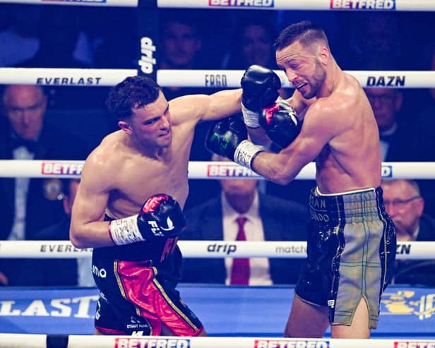 Jack Catterall lands a big left hand on Josh Taylor at the First Direct Arena in Leeds