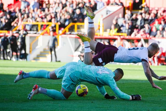 Aberdeen goalkeeper Kelle Roos makes a save from Hearts' Stephen Humphrys at Pittodrie.