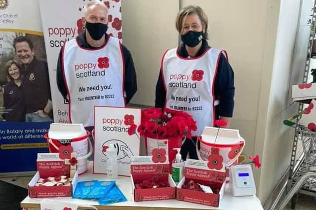 Esk Valley Rotary Club President Elaine Henderson and club member Mark Johnston selling poppies in Morrisons in Dalkeith.