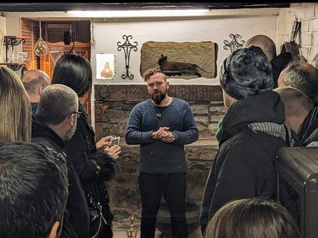 The museum's curator Ash William Mills at the opening night last weekend speaking to visitors.