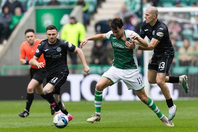 Joe Newell is pulled back by former Hibs midfielder Alex Gogic during the victory over St Mirren at Easter Road. Picture: SNS