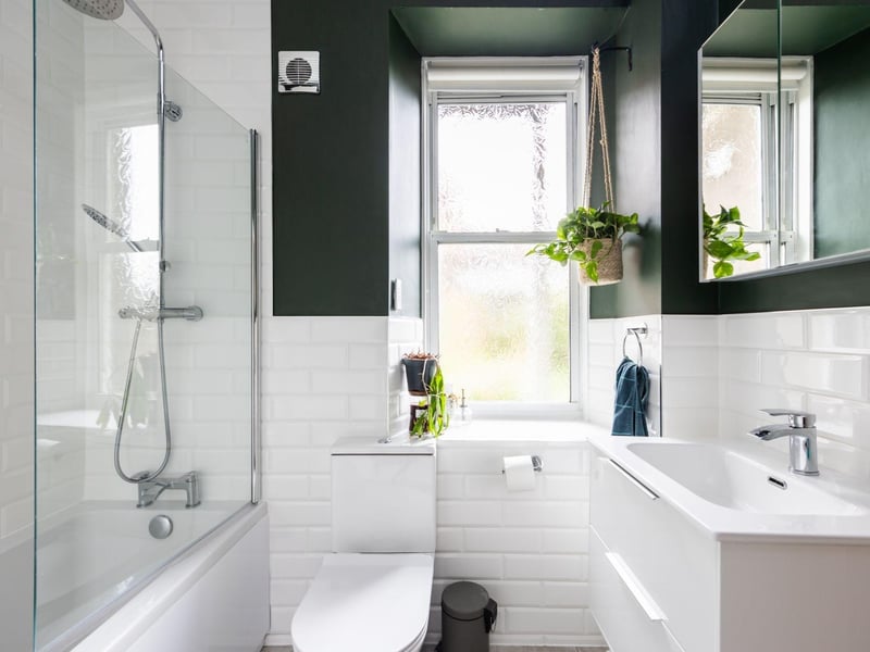 The bathroom is beautifully tiled with subway tiles and includes a three-piece white suite, a thermostatic shower and underfloor heating.