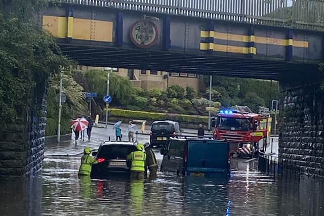Picture taken with permission from the twitter feed of @nicolaawilson showing emergency services helping vehicles which were stuck in flood water under a bridge in Chesser, Edinburgh, during stormy weather on Sunday picture: @nicolaawilson/PA Wire