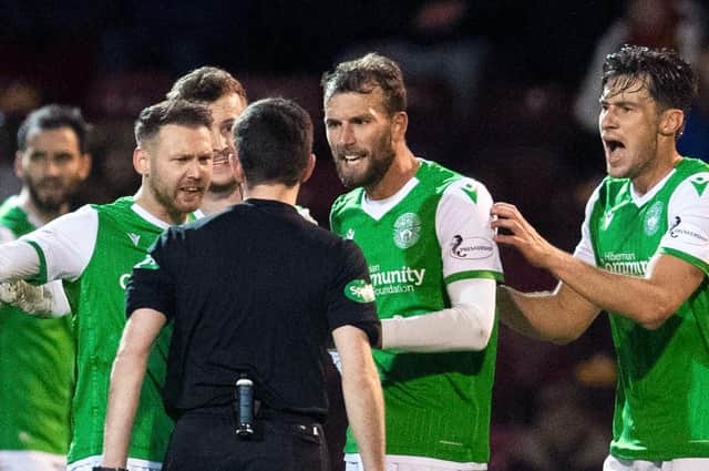 A number of Hibs players engage the referee in discussion during a Scottish Premiership match last season