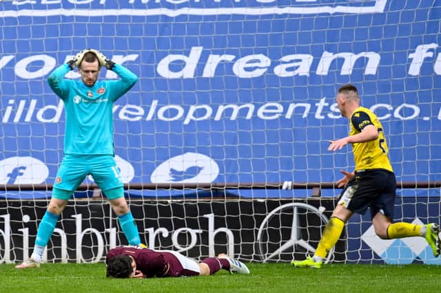 A dejected Andy Irving lies on the turf after inadvertently knocking the ball beyond his own goalkeeper. Picture: SNS
