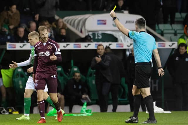 Andy Halliday is shown a yellow card by referee Don Robertson during the Edinburgh derby. Picture: SNS