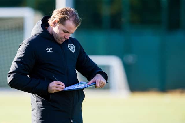 Hearts manager Robbie Neilson takes notes during a training session at Oriam. (Photo by Ross Parker / SNS Group)