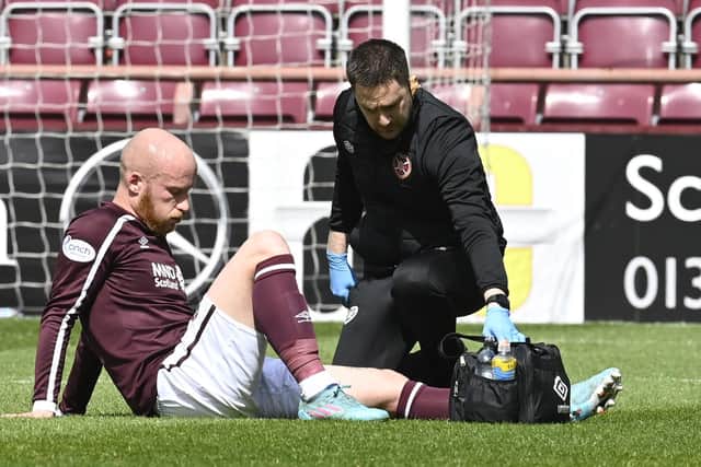 Liam Boyce is forced off injured in Hearts' final game of the season against Rangers. Picture: SNS