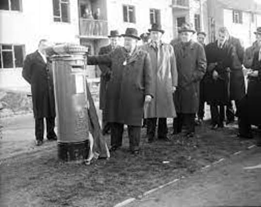 The first letter is posted through the post box which was first in the UK to bear the insignia of Queen Elizabeth II