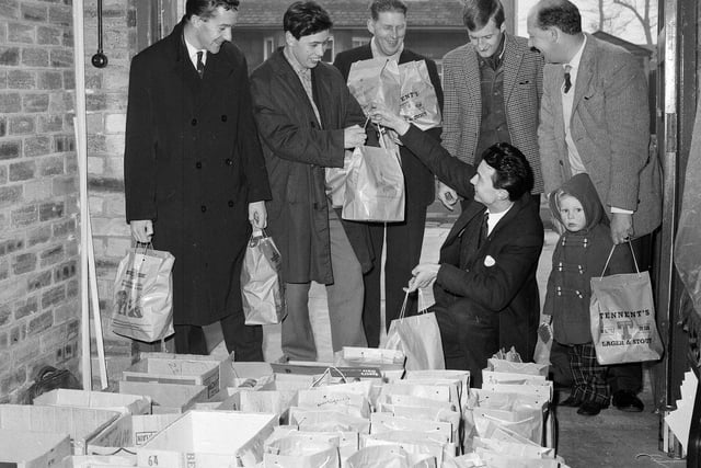 Members of the local Round Table distribute groceries to the old age pensioners of Musselburgh in December 1964.